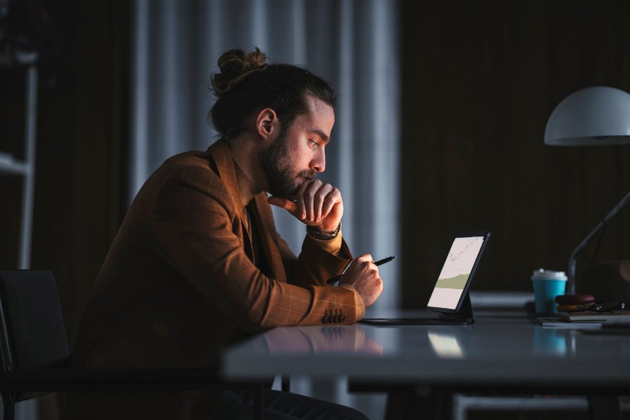 Pensive man working on laptop in office 