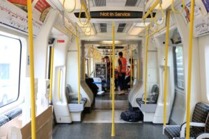 People in hi-viz working on a London Tube train