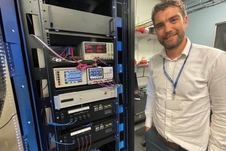 Man stood in front of a large computer frame