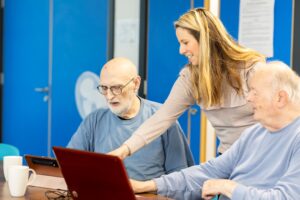 Men using laptop together