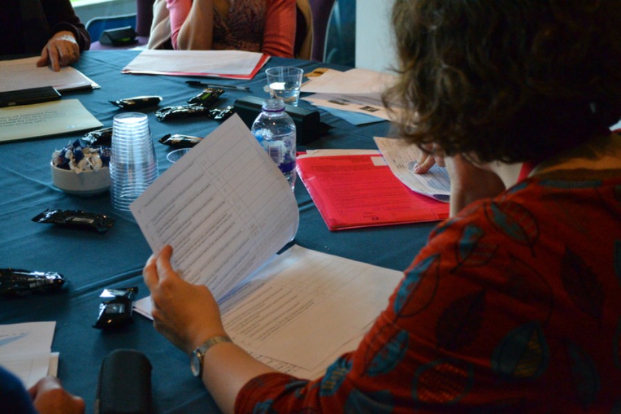 Group sat around a table reviewing paperwork