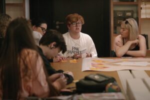 Young people around a table discussing