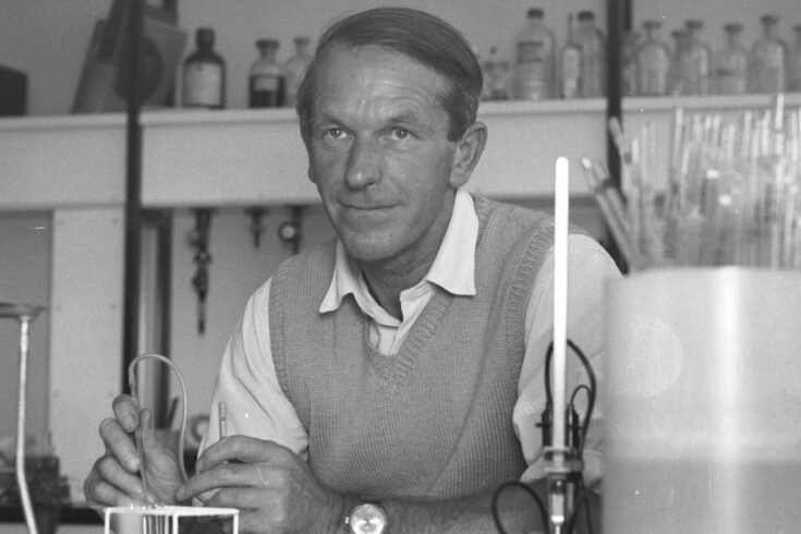 Fred Sanger in laboratory holding pipette