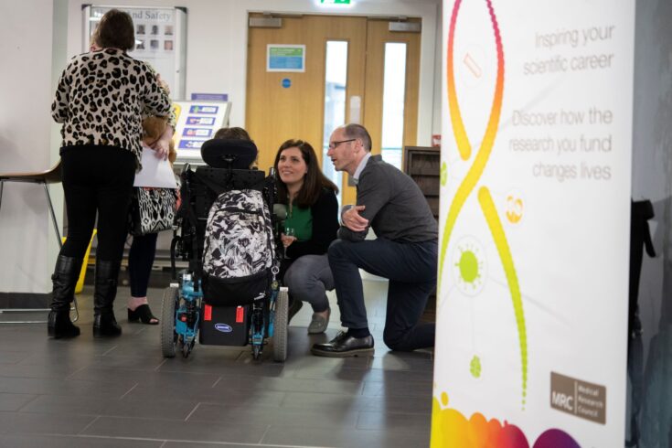 Professors Yanick Crow and Dr Caroline Uggenti talking to a participant at an MRC Human Genetics Unit internal event called ‘Shining a light on rare genetic disease’