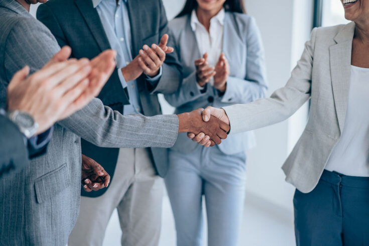 Cropped shot of business people shaking hands in the office.