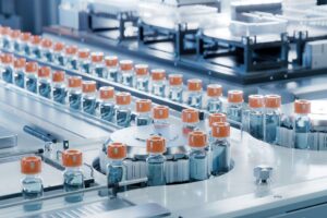 Glass vials on a conveyor belt.