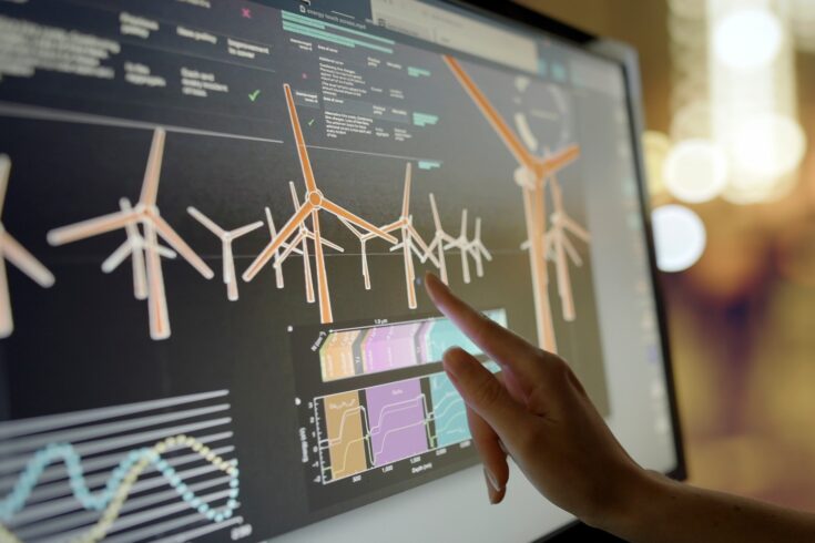 Close-up of a hand using a touch screen monitor