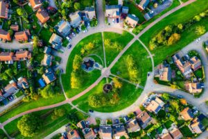 Aerial view of houses and green spaces