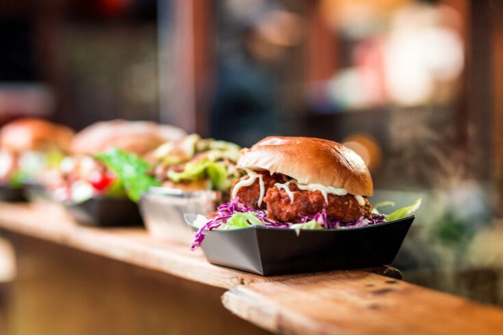 A crispy pork burger at a food market