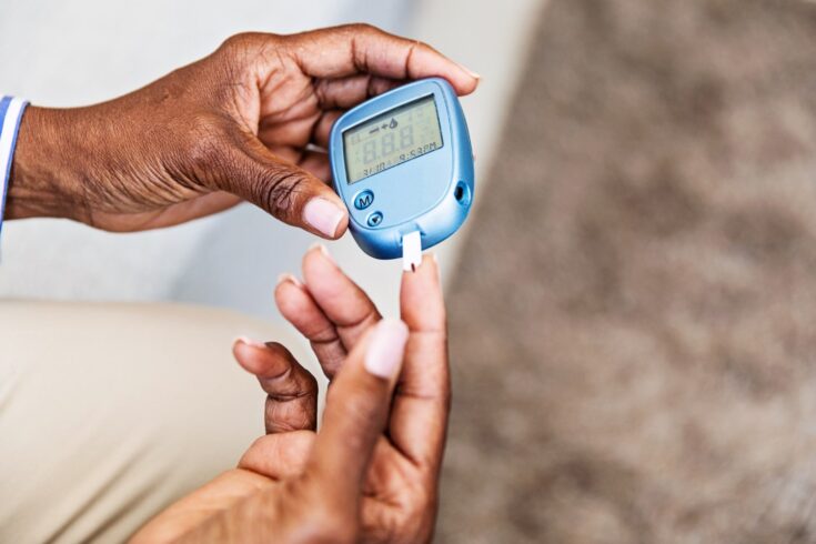 Woman with diabetes checking her blood sugar