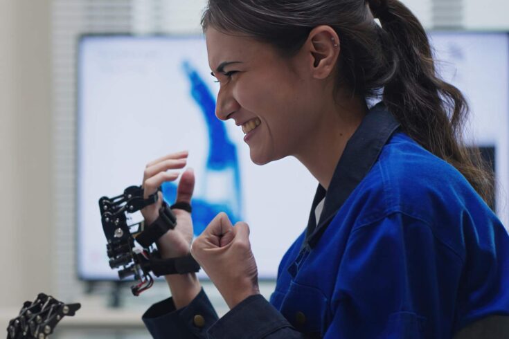 Female engineer using robotic hand