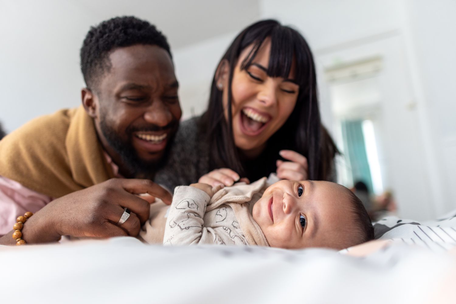 Parents smiling and looking at their baby
