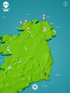 A 3D illustrated map of Ireland and Northern Ireland showing coastal locations marked with orange map pins as part of ‘The Maritime Trail.’ The sea is shown in blue with small wave icons, and a home button appears at the bottom of the screen.